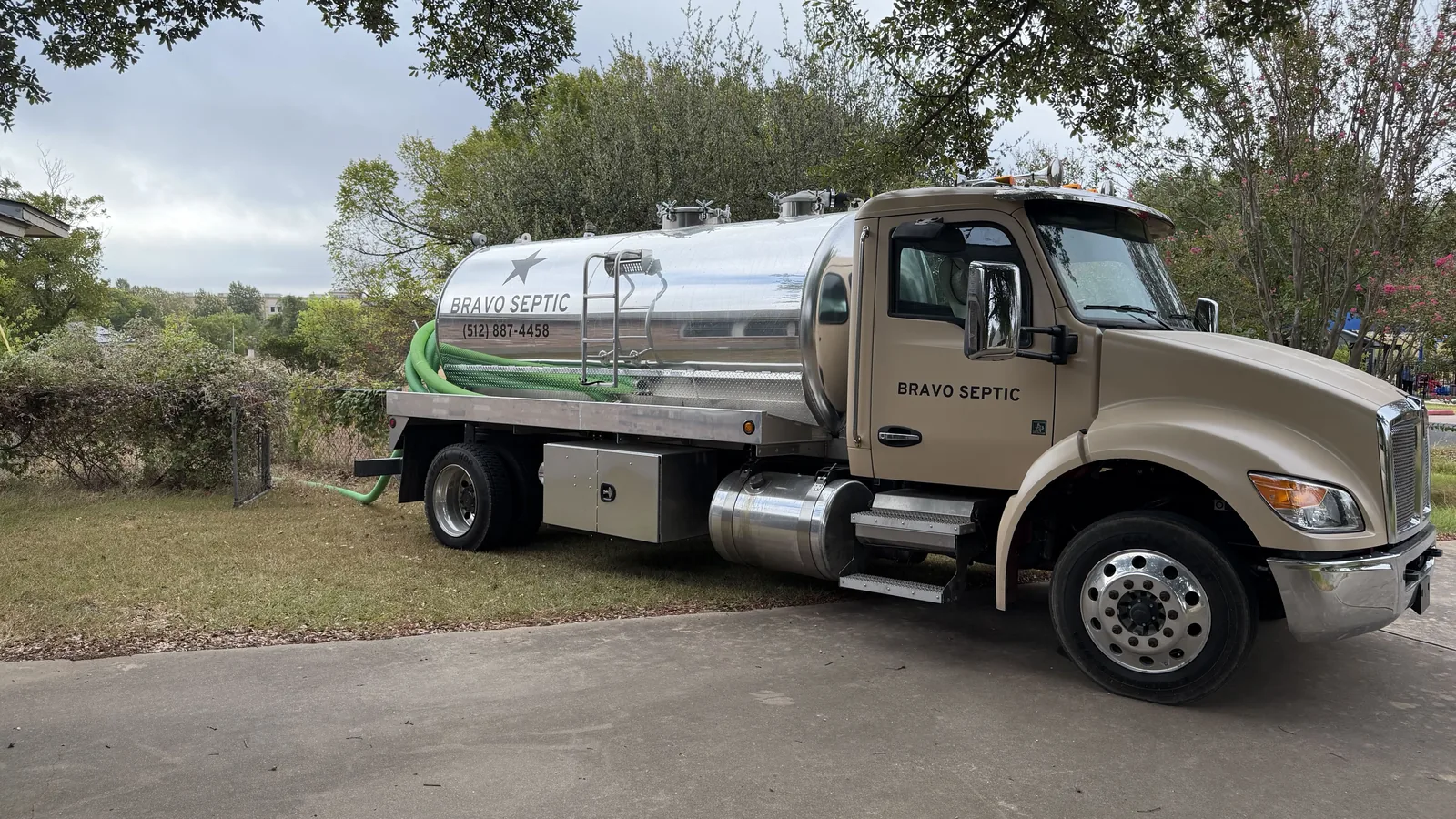 The Bravo Septic pump truck parked on a driveway at a home on a pumping call