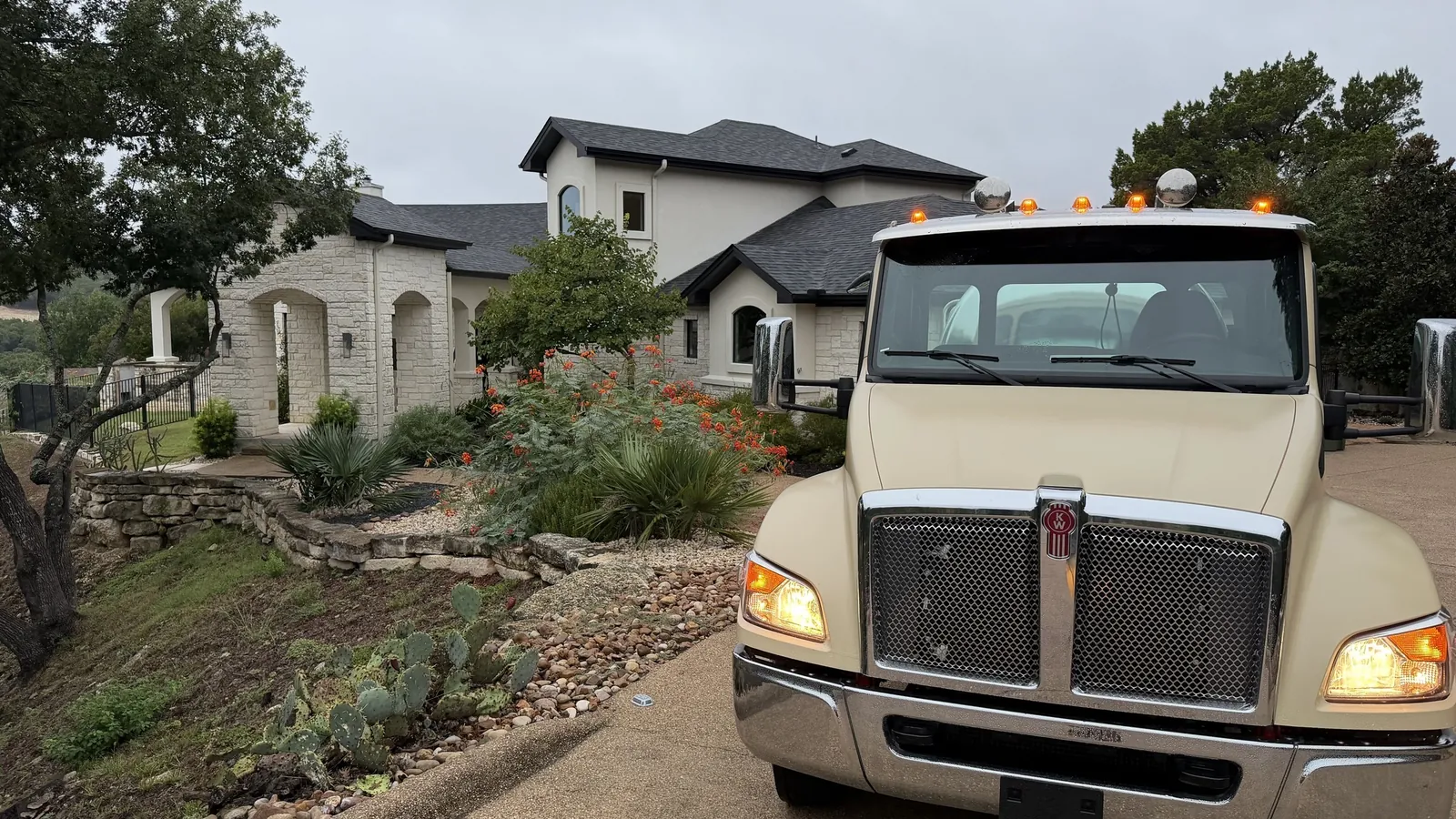 The Bravo Septic pump truck parked on the drive of a stone Hill Country home