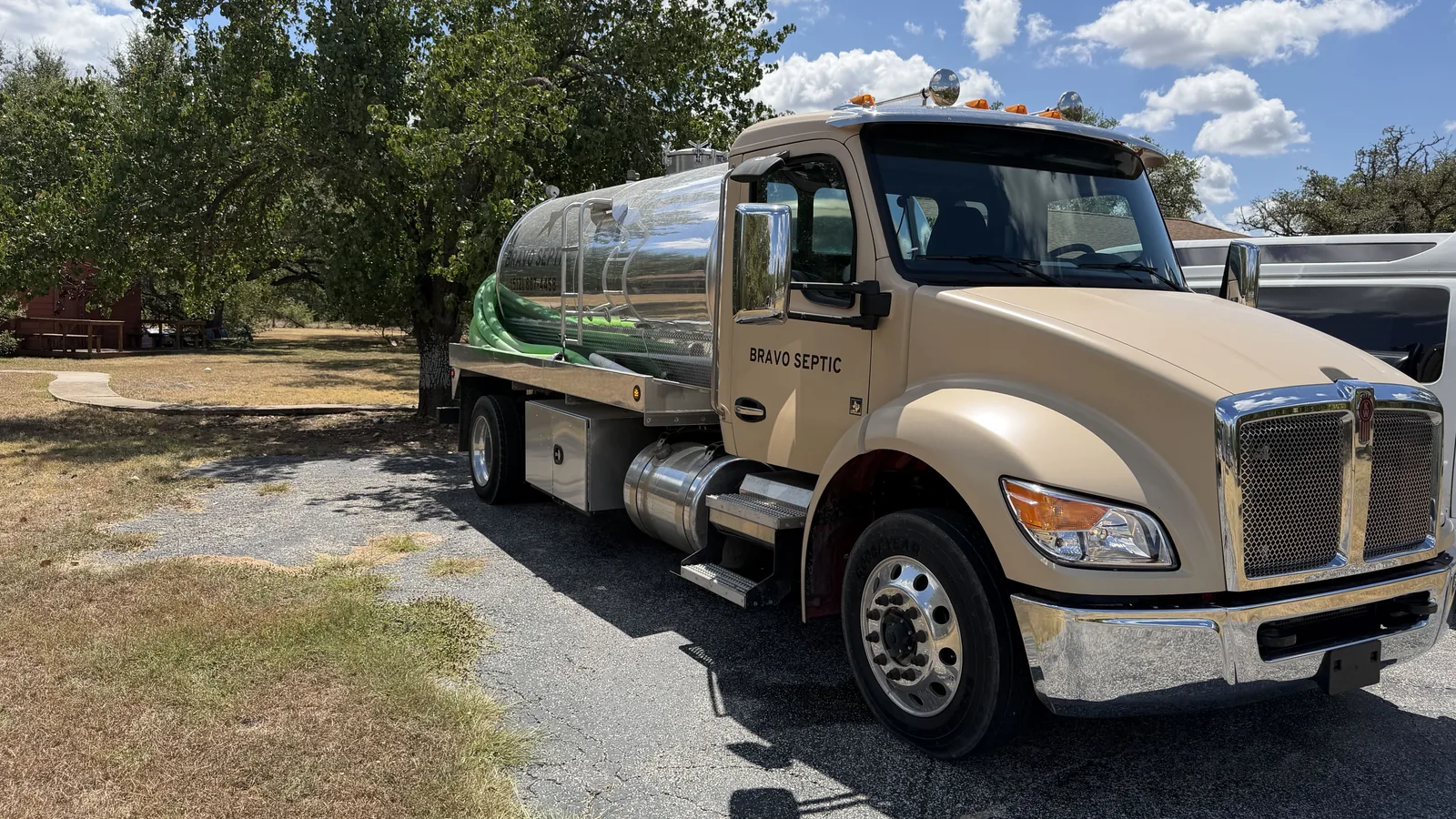 The Bravo Septic pump truck parked under live oaks on a rural property